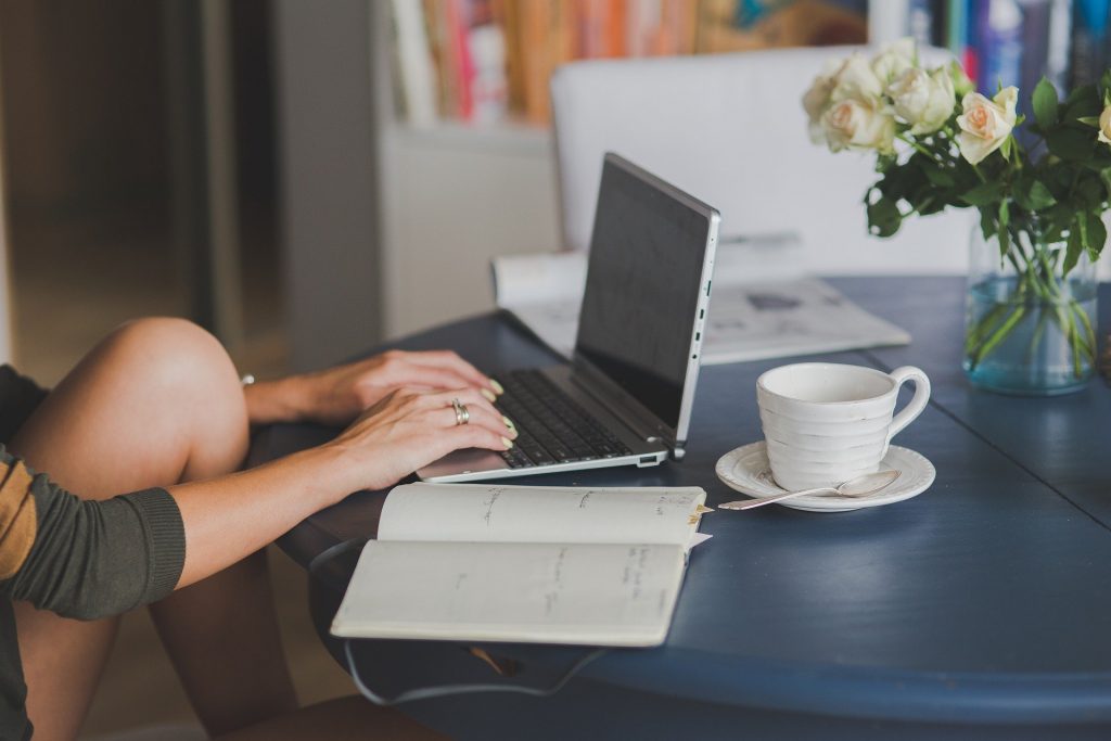 Woman using a laptop on a dining table