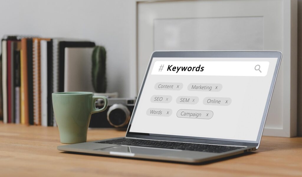 A laptop screen featuring words like keywords, content, marketing and SEO to illustrate SEO keyword research
