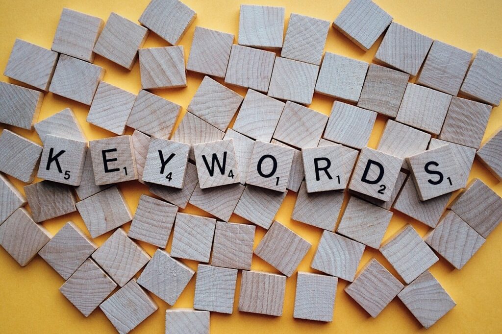 Wooden scrabble tiles spelling our the word 'keywords'